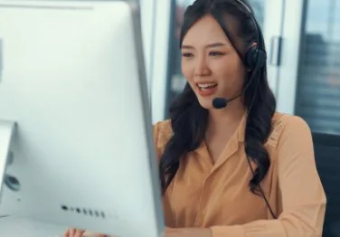 A woman looking at a monitor screen.